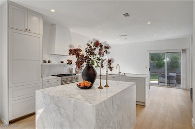 Kitchen featuring a sink, high end stove, a kitche