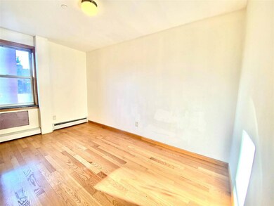 Empty room with light wood finished floors, a base