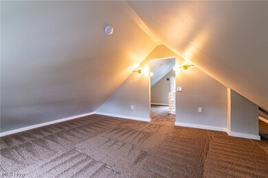 Bonus room with carpet and vaulted ceiling