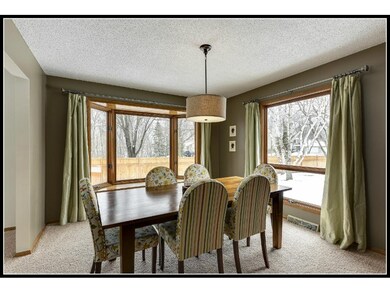 A large bay window in the dining room has a view o