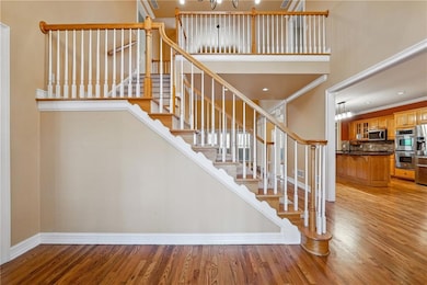 Staircase featuring baseboards, ornamental molding
