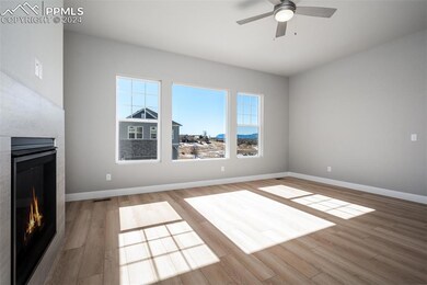 Unfurnished living room with ceiling fan and light