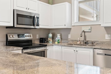 Kitchen featuring stainless steel appliances, whit