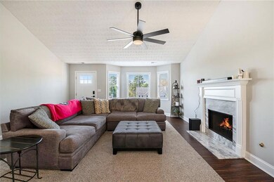 Living area featuring wood finished floors, basebo