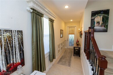 Corridor with light tile patterned flooring and re