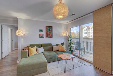 Living room with crown molding and hardwood / wood