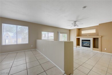 Unfurnished living room featuring light tile patte