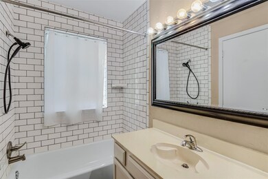 Bathroom featuring large vanity and shower / bath 