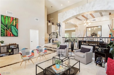 Living room featuring arched walkways, a notable c