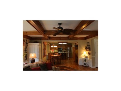 Hardwoods in kitchen open to family room.