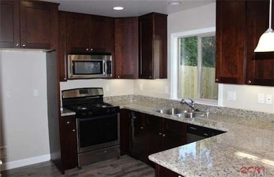 Mocha Java cabinetry, stainless appliances, granit