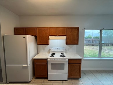 Kitchen featuring white appliances, under cabinet