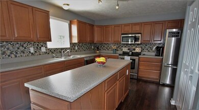 The updated kitchen with mosaic tile backsplash an