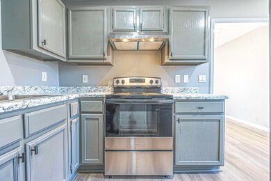 Kitchen with stainless steel range with electric s