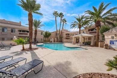 Community pool with fence, a gazebo, a residential