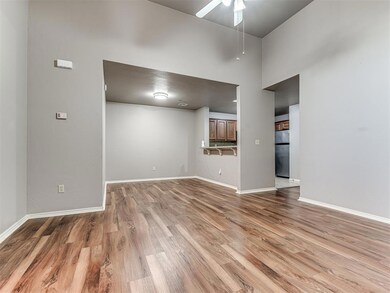 Spare room with wood-type flooring, a high ceiling
