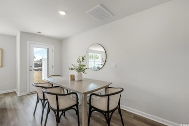 Dining space featuring dark wood-type flooring