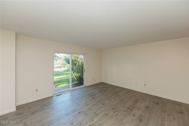 Unfurnished room featuring wood finished floors and baseboards