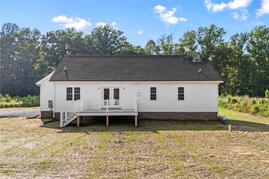 Rear view of house featuring a deck, french doors,