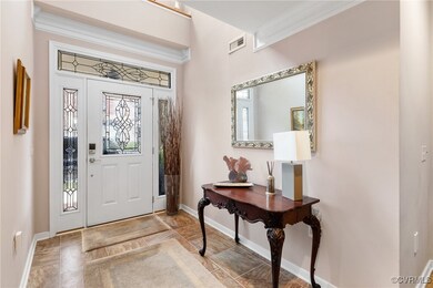 Beautiful Foyer featuring crown molding, a stunnin