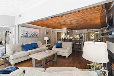 Living area featuring dark wood-type flooring and wood ceiling