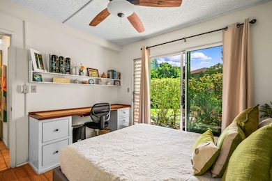 Downstairs bedroom with access to a covered outdoor lanai.