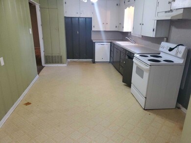 Kitchen with white appliances, under cabinet range