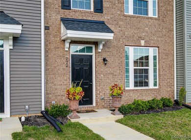View of exterior entry featuring a lawn