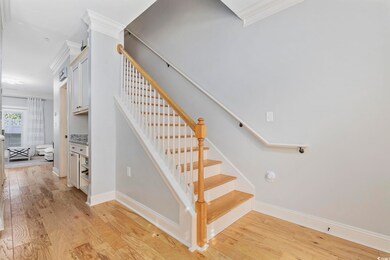 Stairway with wood-type flooring and ornamental mo
