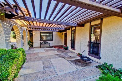 Pergola-covered entry.