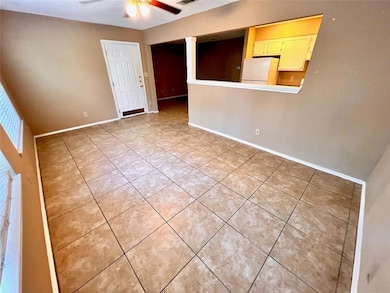 Empty room featuring light tile patterned floors 