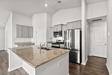 Kitchen featuring light stone countertops, visible