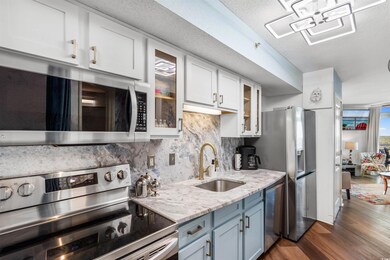 Kitchen featuring white cabinetry, dark wood-type 
