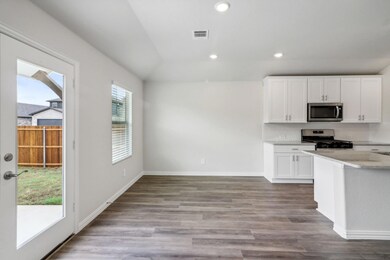 Kitchen with stainless steel appliances, backsplas