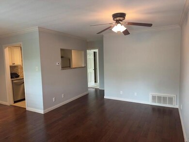 Unfurnished room with a ceiling fan, wood finishe