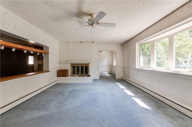 Unfurnished living room featuring ceiling fan, a b