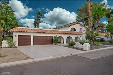 Mediterranean / spanish home with a tiled roof, stucco siding, driveway, and a garage
