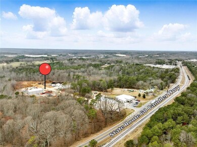 View of property location featuring a forest