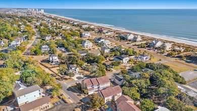 Aerial view featuring a water view and a beach vie