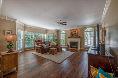 Huge Family w/FP Flanked by Arched Windows & Bay w