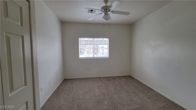 Spare room with carpet floors and a ceiling fan