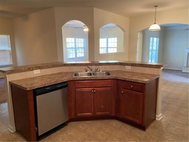 Kitchen with light colored carpet, ceiling fan, si