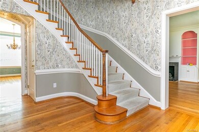 The Entrance Hall features an elegant curved stair