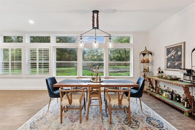 The floor plan is infinitely flexible and this sunny space can be dining, living, game room or work space.  Vinyl windows and pretty plantation shutters were added throughout in 2015.