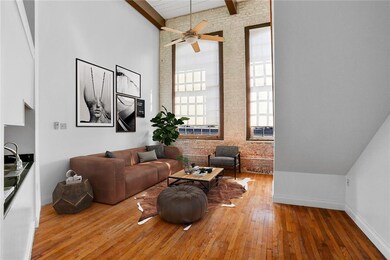This unit's living room has 16 ft ceilings, massiv