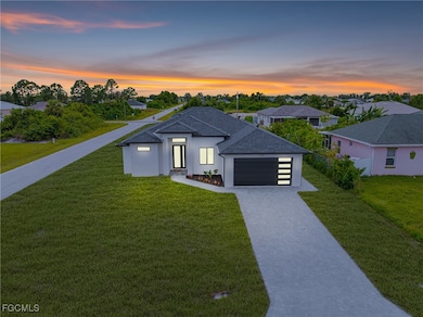 View of front of property with decorative driveway, a garage, stucco siding, roof with shingles, and a front yard
