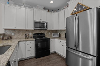 Kitchen with granite countertop and lots of cabinet spaces.