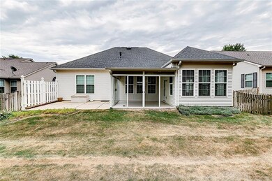 REAR ELEVATION OF HOME SHOWING THE PATIO AND ENCLOSED PORCH.
