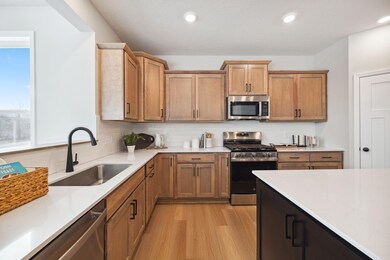 Bright and beautiful, this kitchen shines with warm wood cabinetry, sleek stainless steel appliances, and plenty of counter space to make cooking a joy.