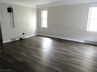 Living room with crown molding and hardwood / wood-style floors